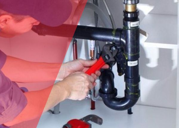 Plumber fixing sink leak