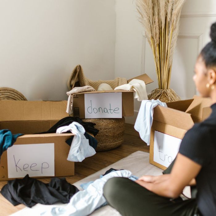 woman deciding what to keep or get rid of woman deciding what to keep or get rid of