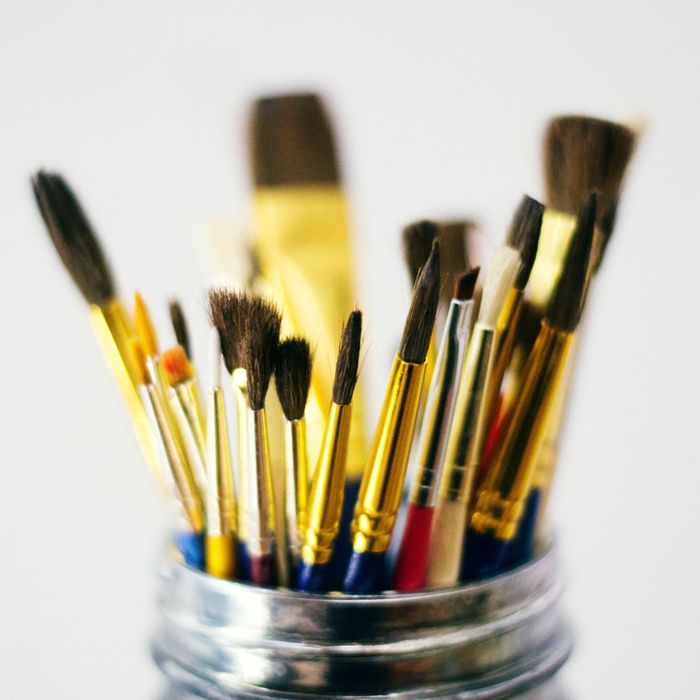 mason jar with paintbrushes