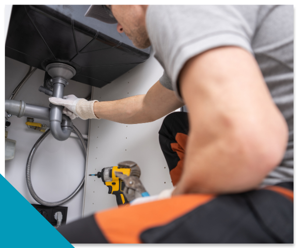 Top Tier Plumbing professional local plumber inspecting residential kitchen plumbing in a Stockton, CA home.