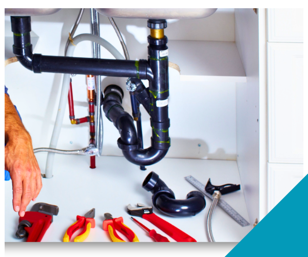 plumbing tools under a sink