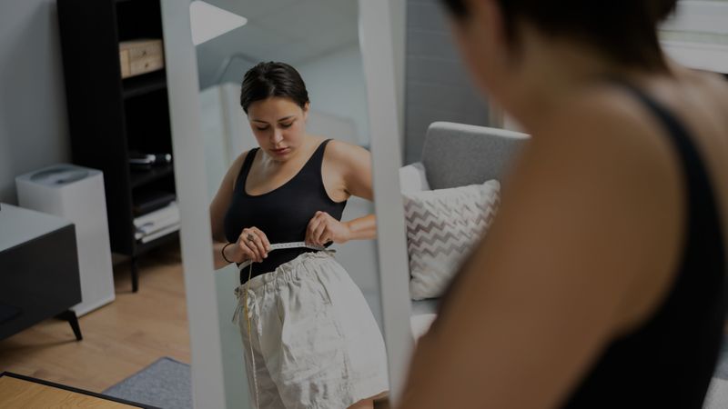 Woman measuring waist