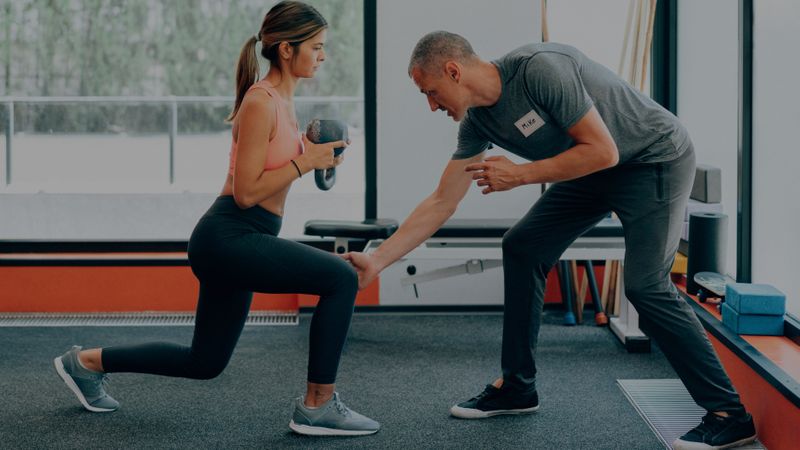 Man training a client with lunges