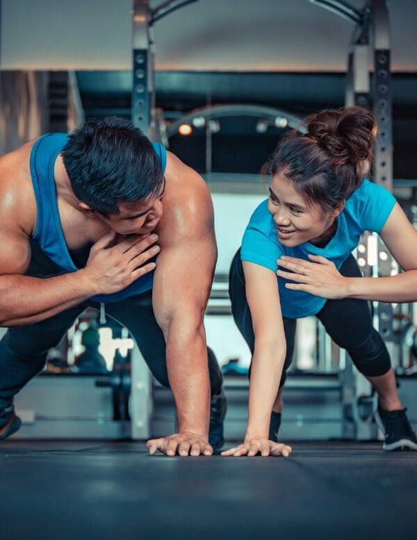 two people doing planks together