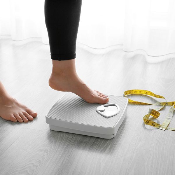 Woman stepping on a scale