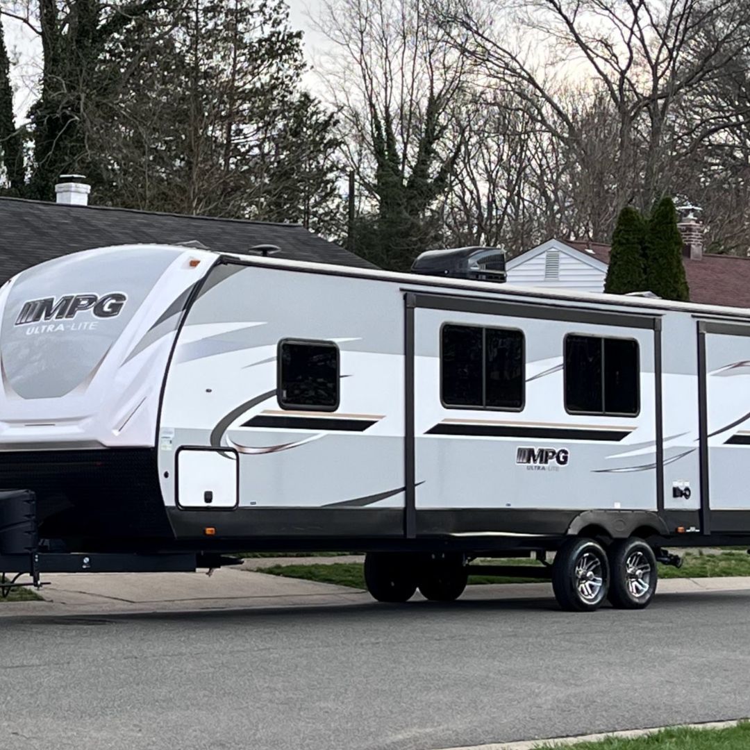 an rv parked outside of a home