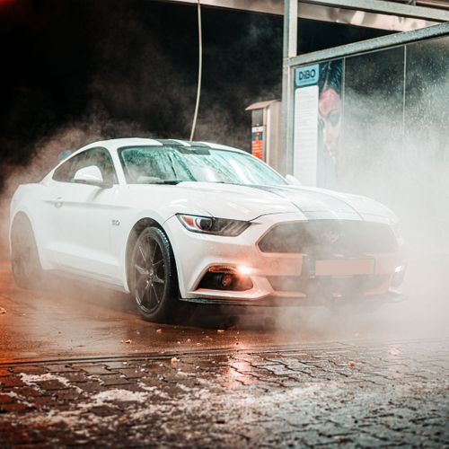 a clean car coming with water around it