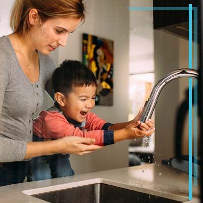 mom and son at sink