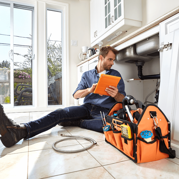 Plumber assessing drain problem