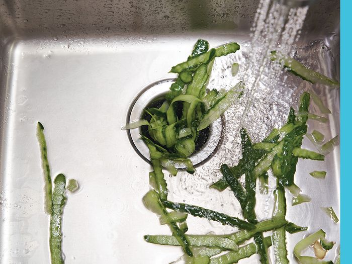 A clog of vegetables in a sink's disposal