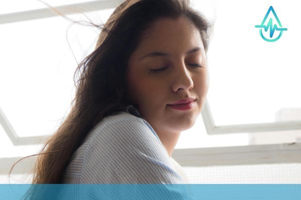 relieved woman against bright window