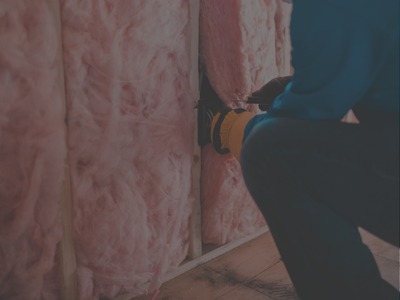 Technician repairing insulation in home