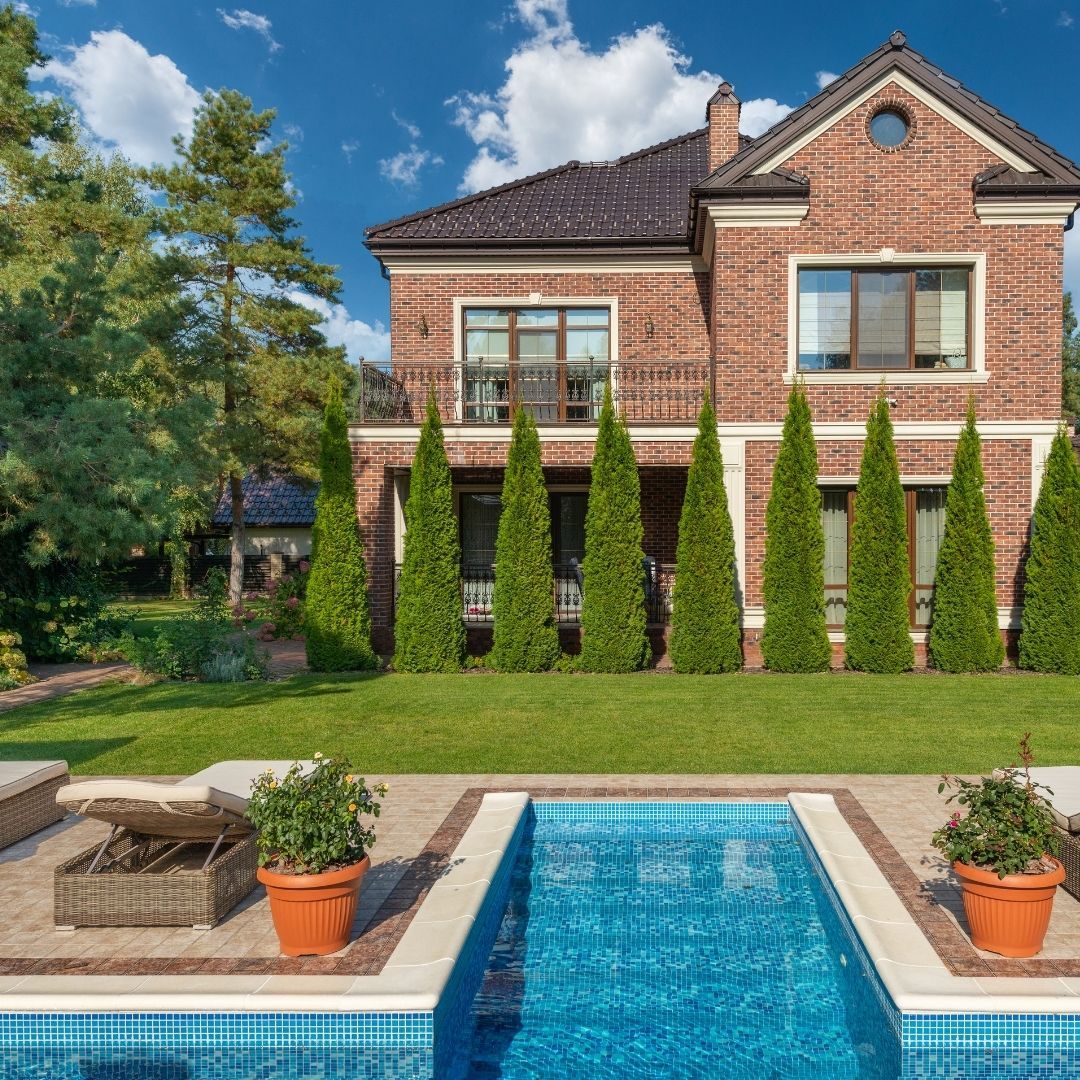 Luxury home with pool in well-landscaped backyard