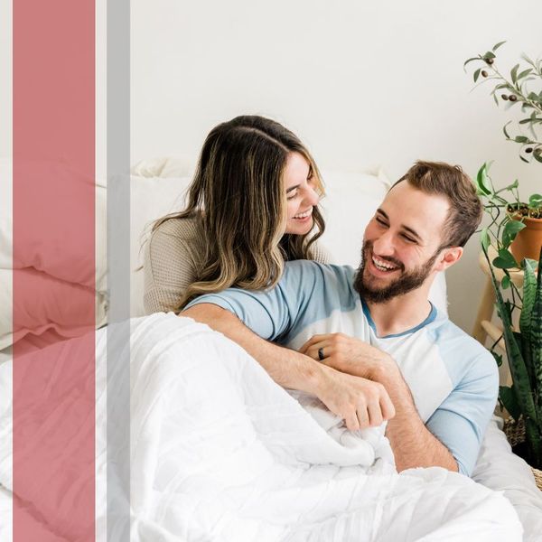 smiling couple in bed