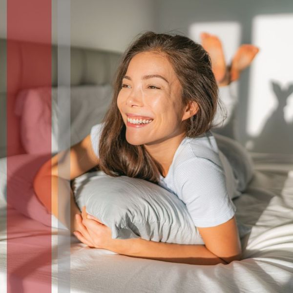 smiling woman lying on bed