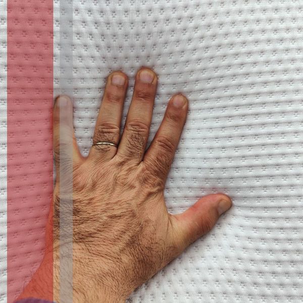 hand on foam mattress