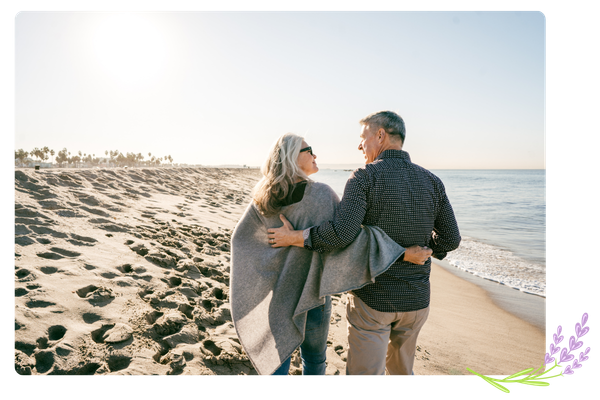 older couple walking on the beach