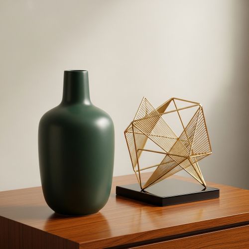 apartment accessories featuring a dark green vase and a gold geometric sculpture