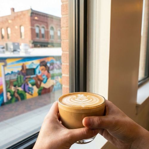 person having coffee and looking out a window