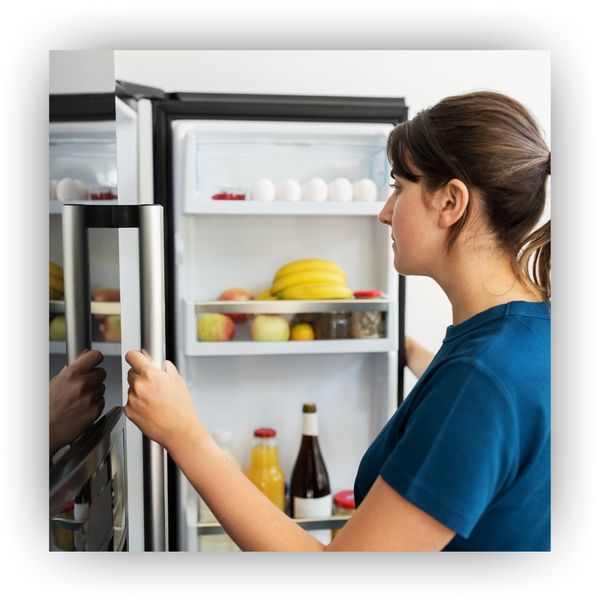 Woman looking in refrigerator