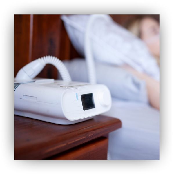 Person sleeping with a CPAP machine