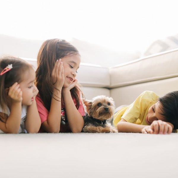 kids laying down with a dog