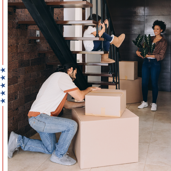 family unpacking in modern home, young child hanging out on stairs