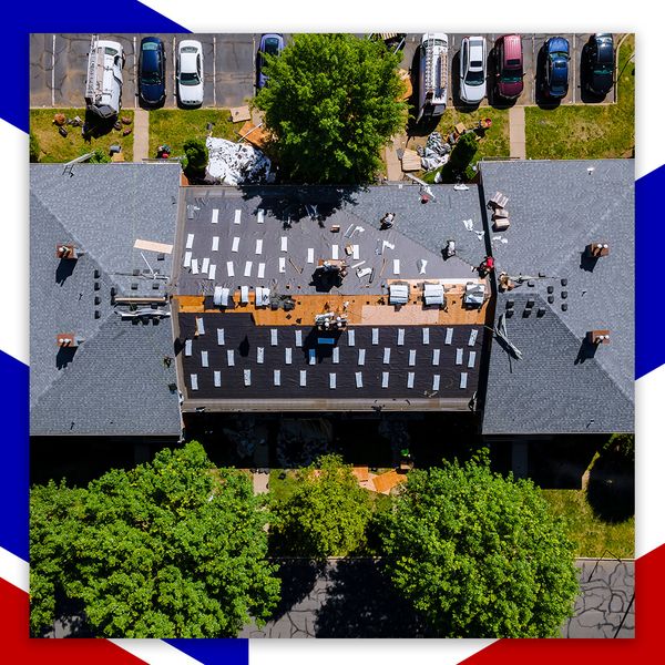 roofers working on commercial building roof