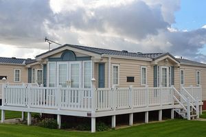 Mobile home with white fence