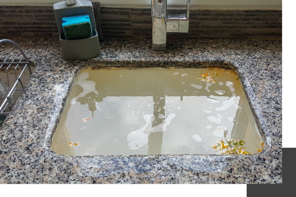 clogged kitchen sink filled with water