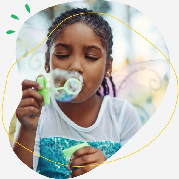 Little girl blowing bubbles