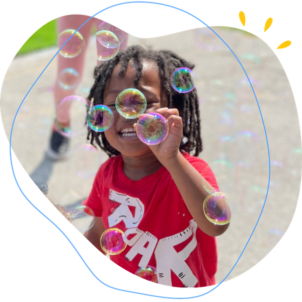 Little boy playing with bubbles