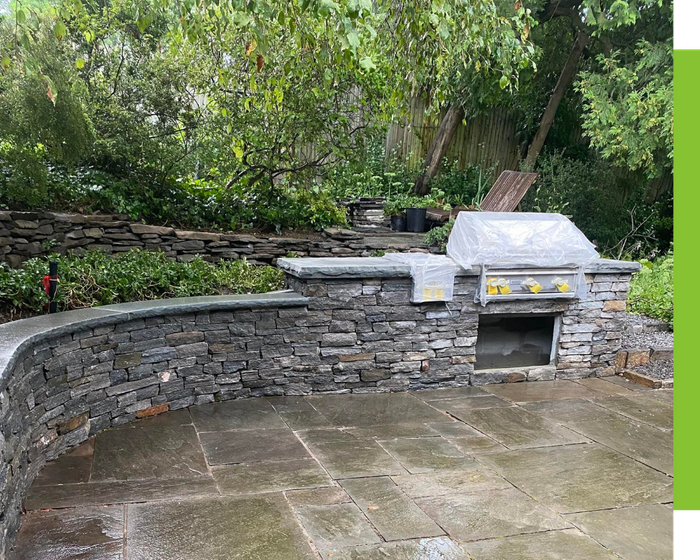 built in outdoor kitchen with durable retaining wall