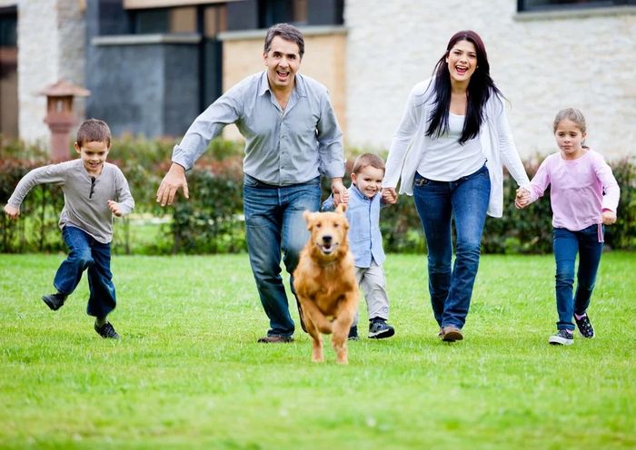 Happy family running with their dog outdoors.jpg