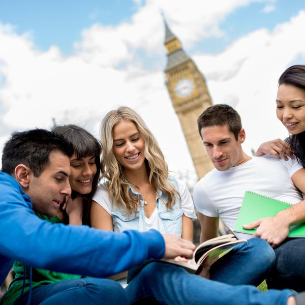 Group of people sitting with books in front of Big Ben
