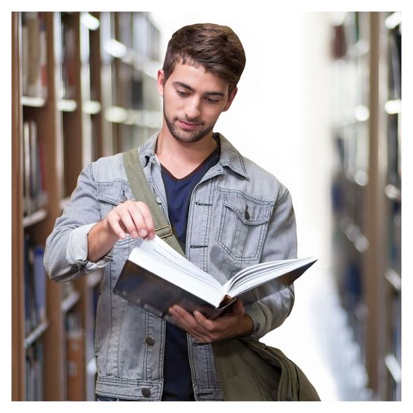 young man looking at text book