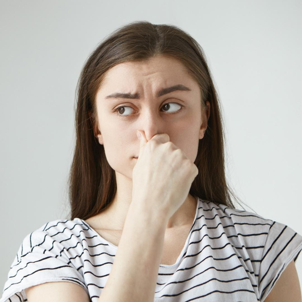 Image of a woman holding her nose