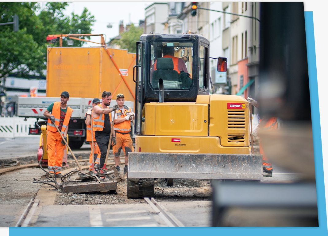 crew with heavy machinery working on city street