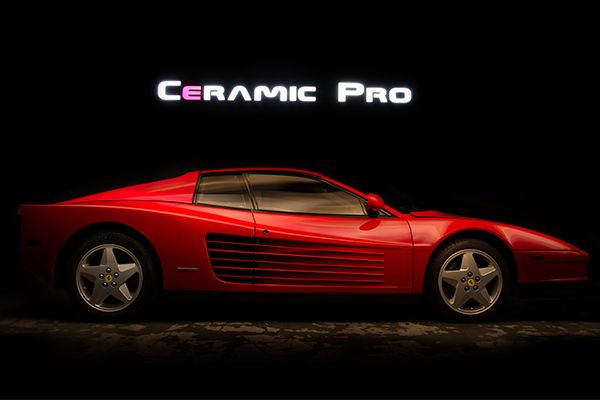 Red Ferrari with Ceramic Pro logo
