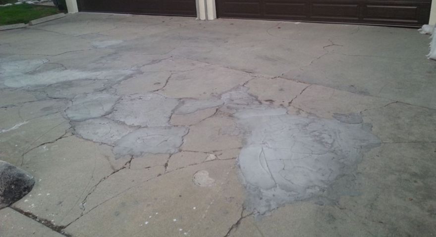 Severely cracked driveway before being worked on by RAD Concrete