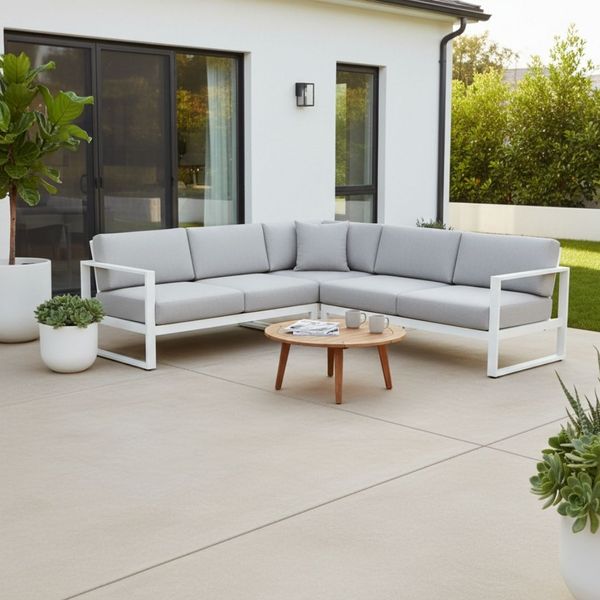 Stylish outdoor seating area on a seamless, light-colored decorative concrete patio.