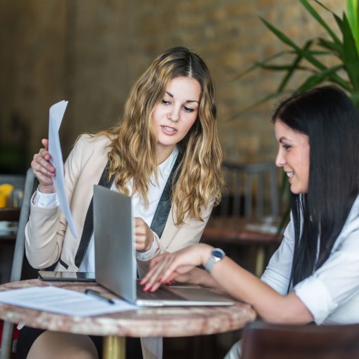 two women working on a laptop