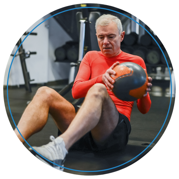 man using medicine ball to work out