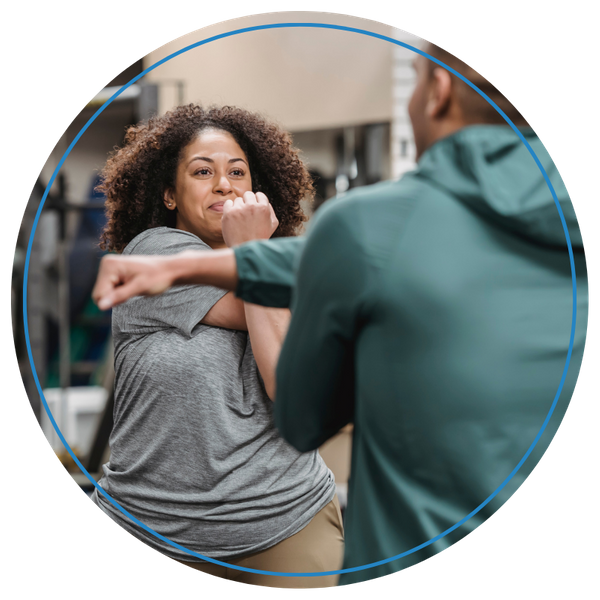 woman stretching with trainer 
