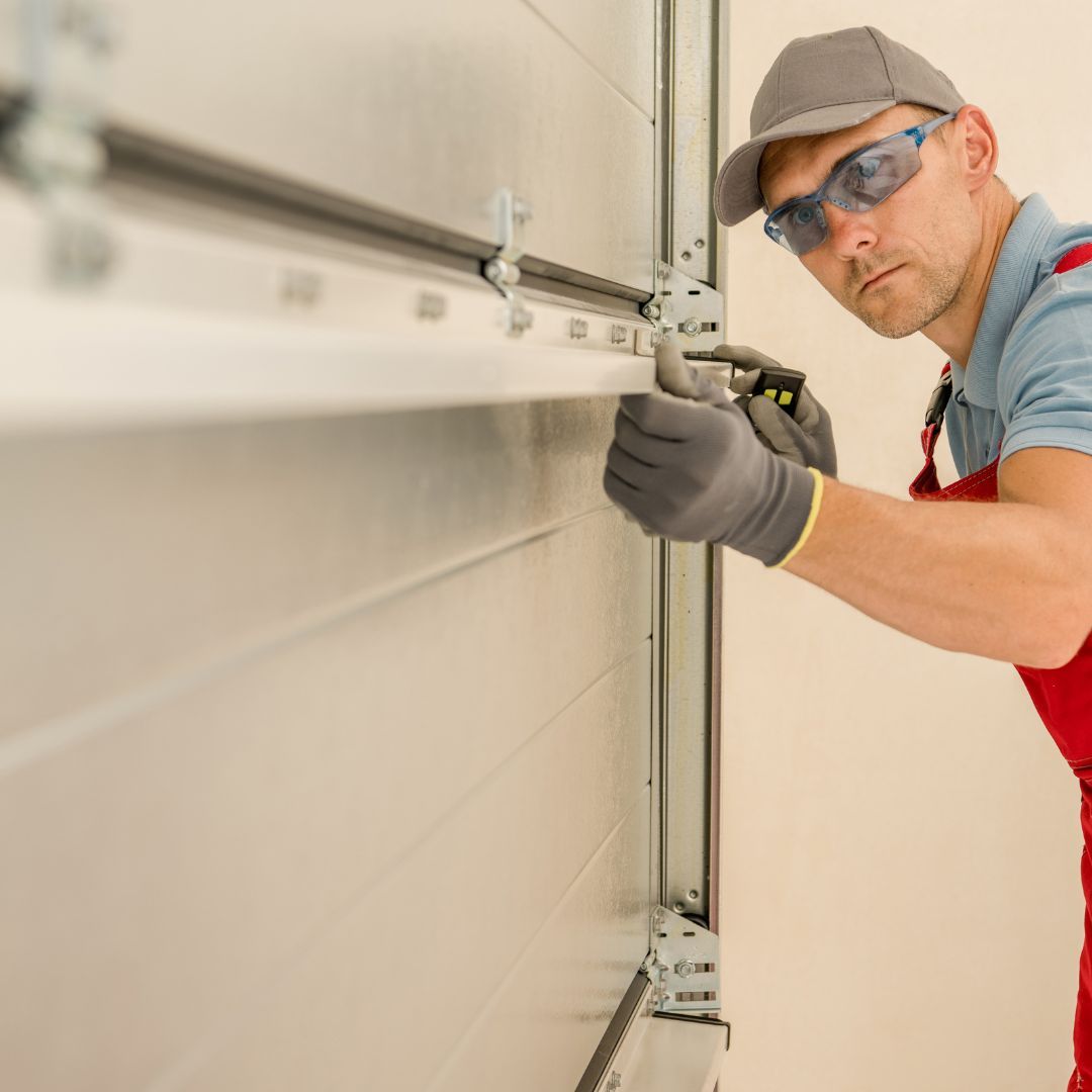 Man inspects garage door rails