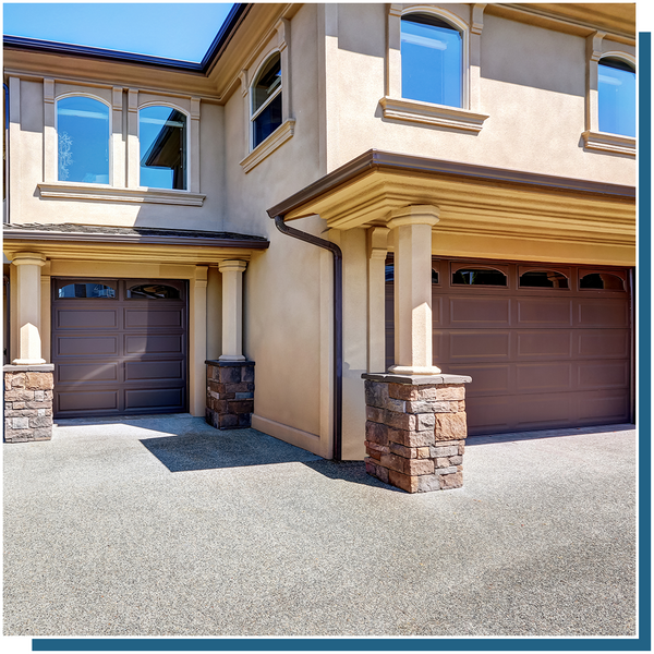 stucco house with a 3 car garage with brown garage doors