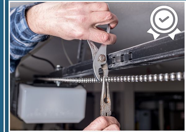 garage door technician repairing chain