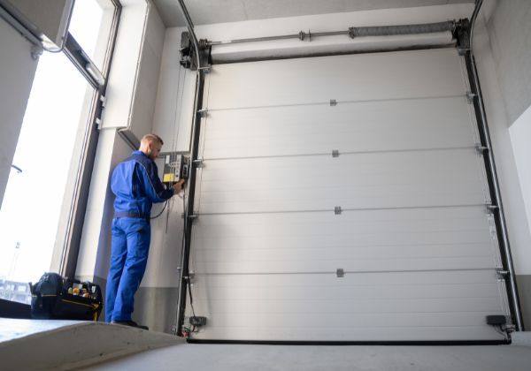 garage door contractor repairing door