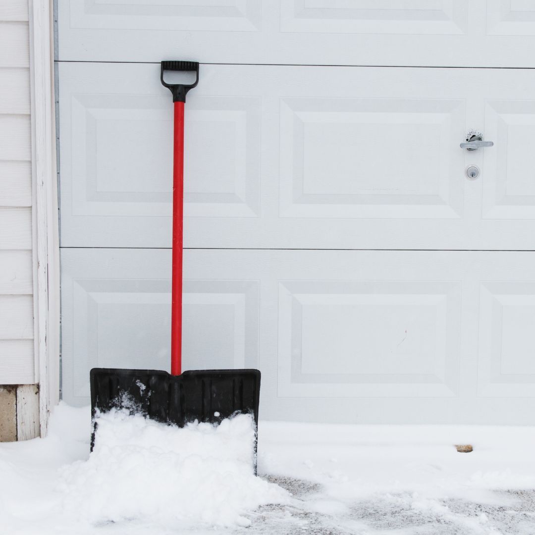 shovel, snow and ice near garage doors