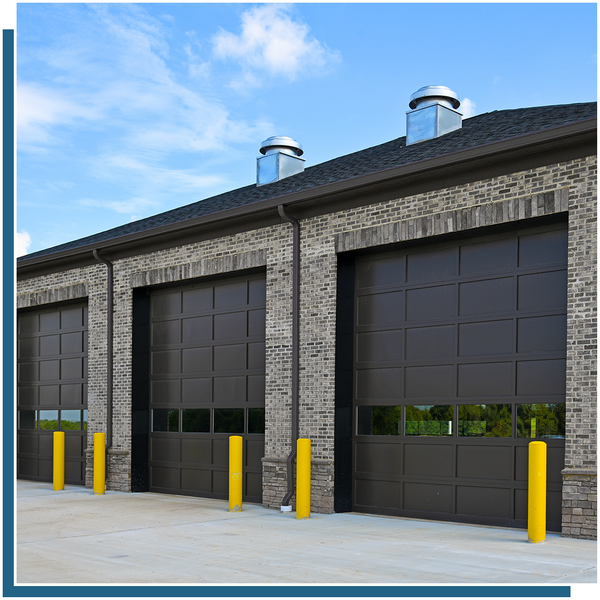large black garage doors with windows brick commercial building